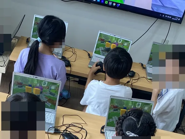 Children working on laptops at our center